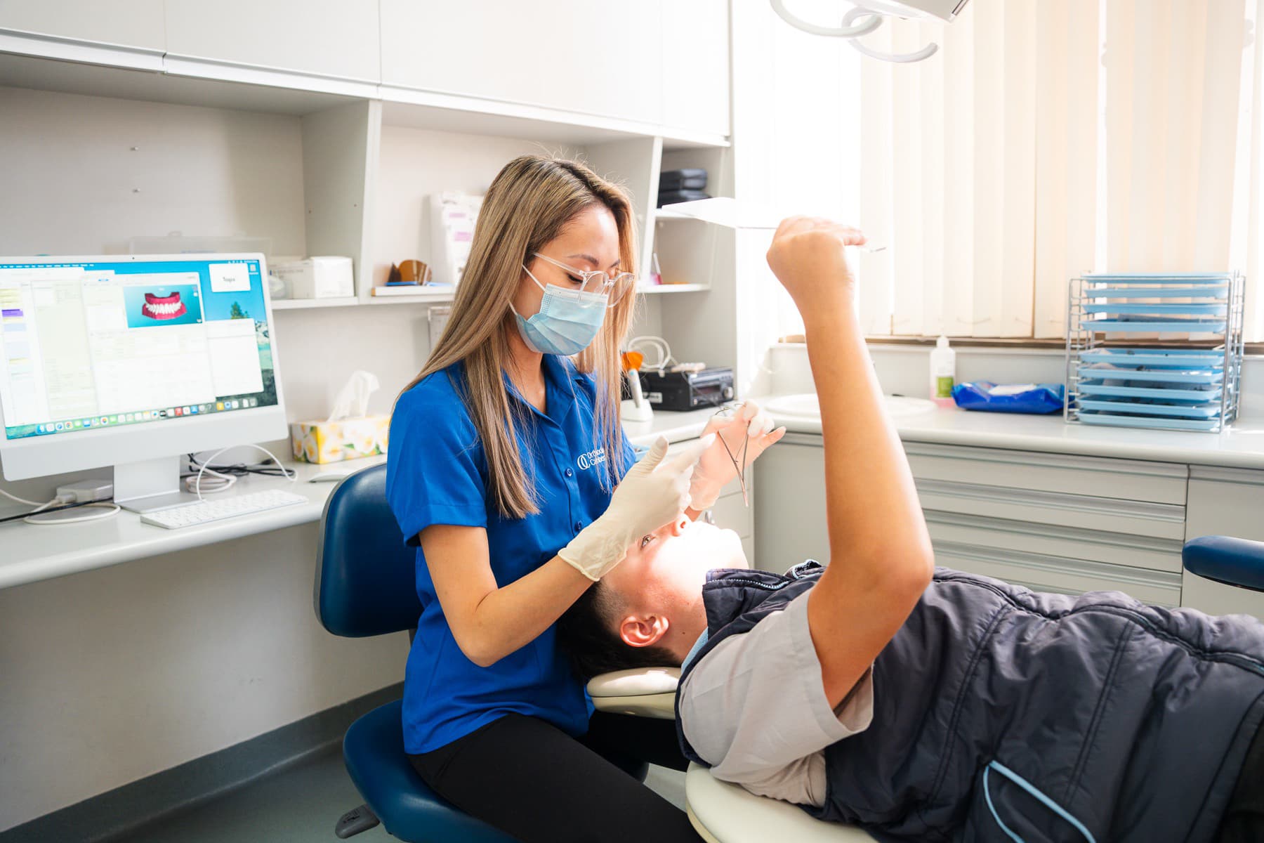 Dental assistant explaining treatment to a patient