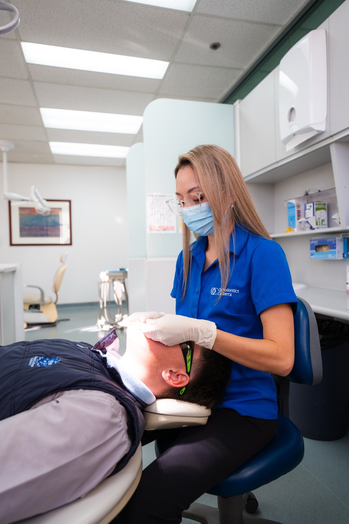 Dental assistant placing ceramic braces